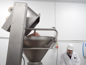 sausage meat being loaded for processing into finished sausages